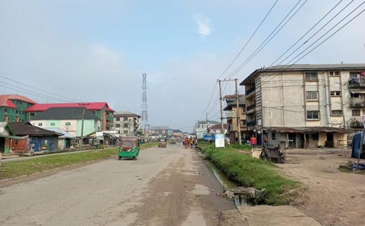 along Ikot Ekpene road by Amy Checkpoint